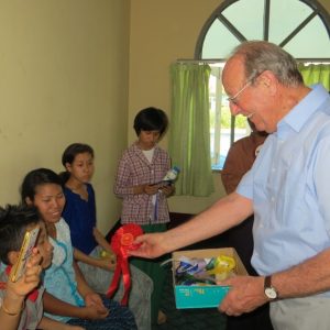 David handing out rosettes at Mandalay school