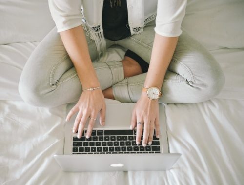 Woman writing content on her laptop