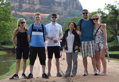 A group of volunteers standing in front of a mountain in Sri Lanka