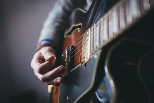 deaf person playing a guitar