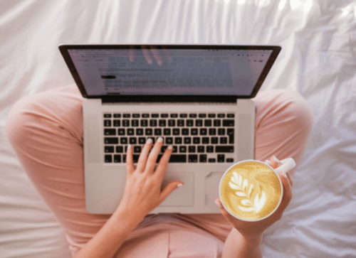 laptop and coffee on lap