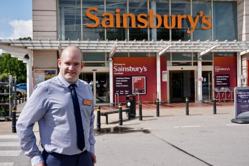 Role Model Jonathan standing in his uniform outside his Sainsbury's branch
