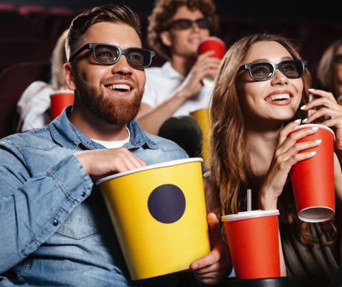 Man and woman enjoying the cinema and popcorn but not deaf people