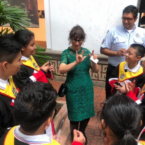Vice chair of WFD meeting with deaf children in Guatemala and signing with them