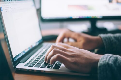 a laptop with hands typing